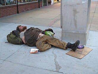 Homeless_man_sleeping_on_Colfax_Street,_Denver