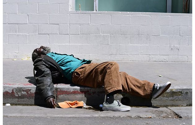 Level 1 homeless black man sleeping on the streets
