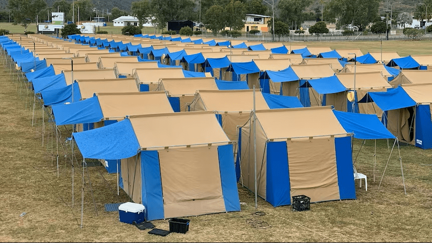 ead4007ff15b4e99d008b17d6e4f9f62 uniformed tents in rows, making a tent city